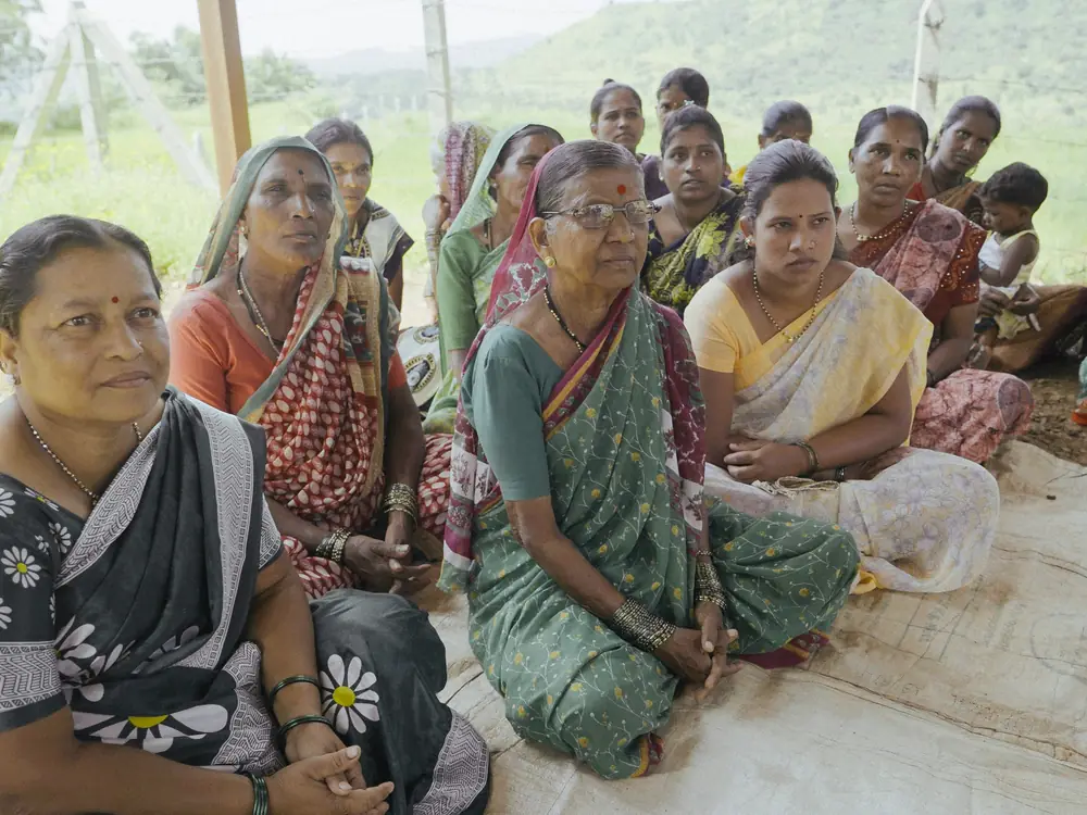 A group of women from a self-help group sitting together and listening